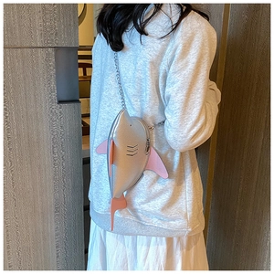 Creative silver shark shaped crossbody bag with metallic finish and pink chain detail