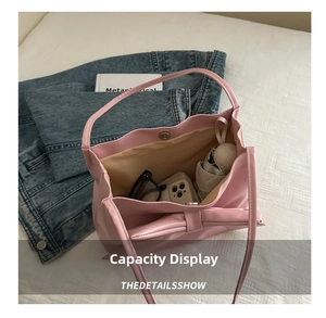 Pink bow tote bag detail showing large capacity for umbrella, phone, and sunglasses
