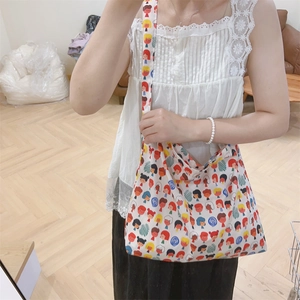 Detail of cute cartoon printed cotton crossbody bag featuring wide soft shoulder straps
