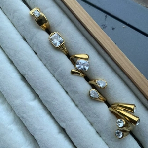 Detailed view of vintage gold-plated titanium rings with sparkling zircon in a jewelry box
