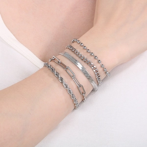 Detail showing set of five silver titanium steel bracelets with various chain patterns