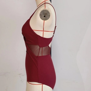 Detail of burgundy one-piece swimsuit featuring sexy side mesh panels and thin straps