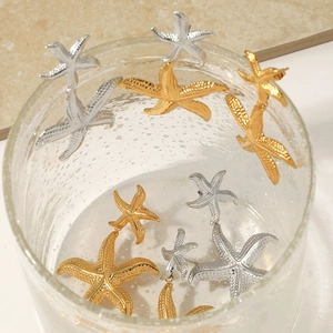 Textured starfish dangle earrings in gold and silver finish with marine style