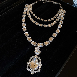 Multilayer silver necklace with rectangular crystals and a large pear-shaped drop pendant
