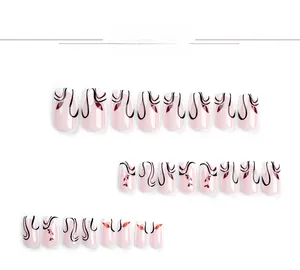 Detail view of 24 press-on nails with black curves and dark red floral leaf patterns