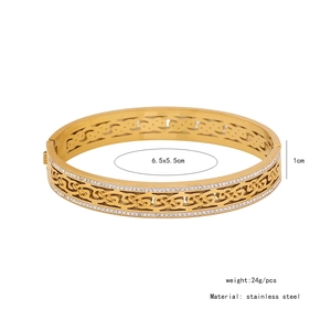 Detailed view of hollow braided stainless steel bangle with side sparkling rhinestones