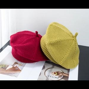 Red and yellow knitted beret hats with pumpkin design in high-quality wool texture