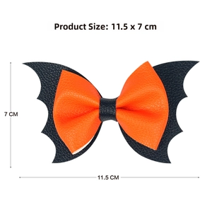 Close-up of orange bow hair clip with black bat wings and dimension measurement labels