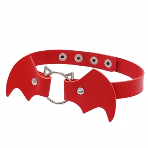 Detailed macro view of a red leather bat wing collar with a cat ear metal ring fastener