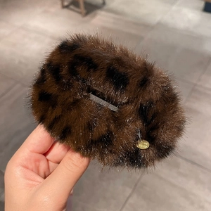 Plush leopard print hair clip in brown and black faux fur with an elegant oval silhouette
