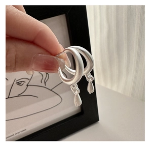 Detail of S925 sterling silver drop earrings with matte finish and C-shaped design