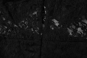 Gros plan sur le tissu en dentelle noire avec motifs floraux et fermeture éclair invisible