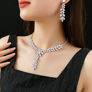 Close-up of sparkling zircon wheat ear tassel necklace and earrings set on a model