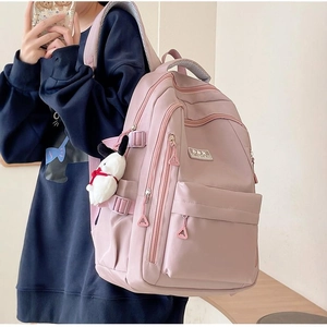 Pink large capacity student backpack with ergonomic straps and cute plush pendant