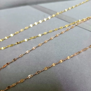Collane minimaliste a maglia a labbro in oro e oro rosa su un vassoio espositore