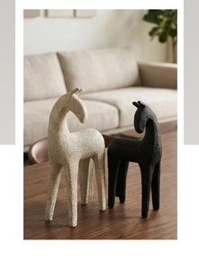 Close-up of minimalist resin horse statues with a textured sandstone finish for home decor