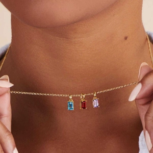 Gold titanium steel necklace with rectangular blue, red, and purple zircon pendants on model