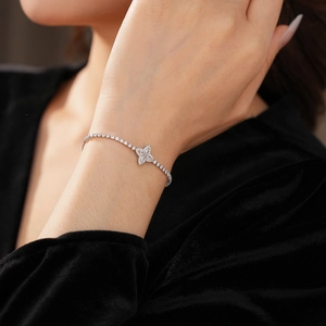 Macro shot of a sparkling silver flower bracelet with zircons worn on a wrist