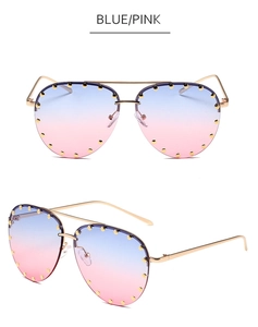 Detail view of aviator sunglasses with gold rivets and blue-pink gradient lenses