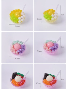 Detailed macro view of miniature dessert bowls with colorful fruit and ice cream toppings