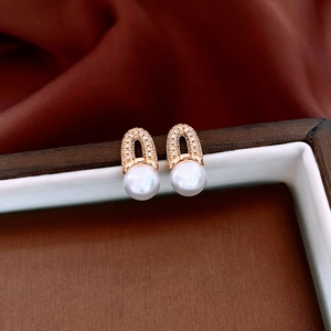 Detailed view of 18K gold plated hoop earrings with shimmering crystals and white pearls