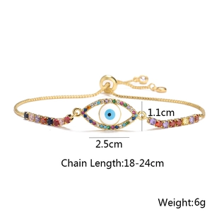 Macro detail of adjustable gold evil eye bracelet with colorful zircons and snake chain