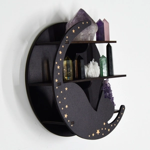 Detail of black wooden cat moon shelf with gold stars displaying colorful crystals
