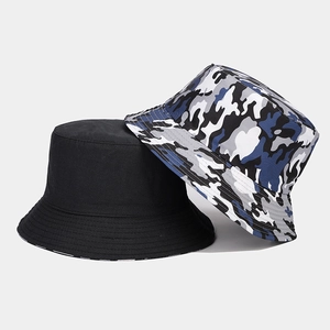 Detail of dual-sided bucket hat in solid black and grey camo print twill cotton fabric