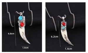Detailed size comparison of two vintage wolf tooth pendants with engraved metal accents