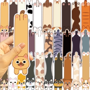 Close-up of cute cartoon cat and dog paper bookmarks held by hand with various designs
