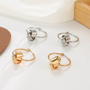 French style knotted circle hoop earrings in gold and silver finish on white silk