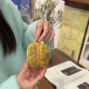 Detail of yellow plush protective case with pearl zipper charm and Sozakka brand tag