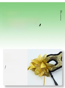 Detail of golden masquerade mask with sequin embroidery, side fabric flower and hand-held stick