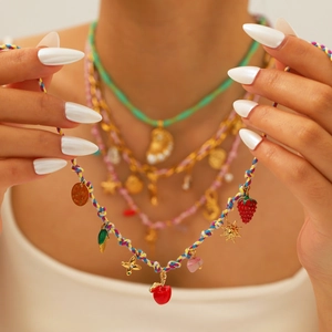 Bohemian colorful woven rope necklace featuring gold strawberry and star pendants