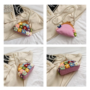 Detail of pink woven flower shell bag with pearl chain strap and wooden clasp closure