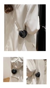 Vertical collage showing a glossy black heart-shaped mini crossbody bag with a silver chain