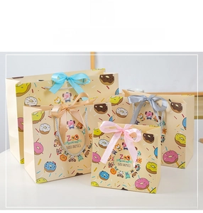 Detailed view of assorted cartoon animal gift bags with colorful ribbon bows in various sizes