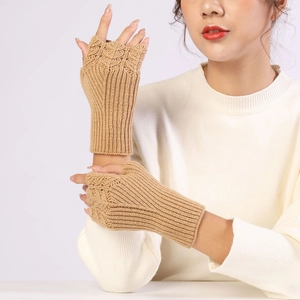 Detail of camel knitted fingerless gloves with elegant cable knit texture and wrist cuff
