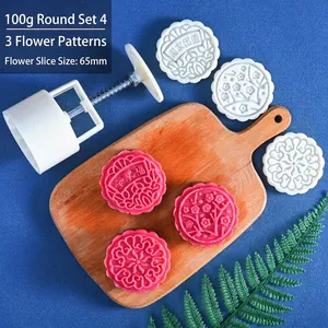 Detail of 100g round mooncake press with three flower stamp patterns and handle