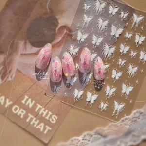 Macro shot of thin and resilient white butterfly nail stickers and ballet style gradient nails