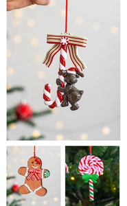 Detailed view of polymer clay gingerbread man and candy cane Christmas ornaments