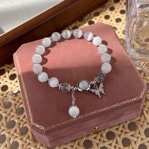 Elegant cat eye stone bead bracelet with silver butterfly charm on a pink velvet box