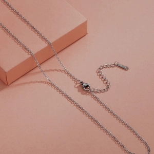 Detail of silver stainless steel necklace featuring extender chain and lobster clasp