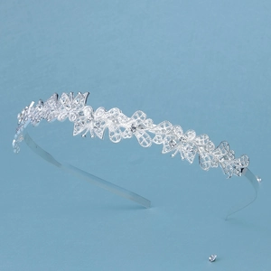 Detailed view of silver crown headband with floral lace pattern and sparkling rhinestones