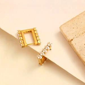 Elegant gold square hoop earrings with inlaid oval zircons on minimalist stone background