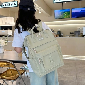 Light green Japanese school backpack with multiple pockets and cute bear embroidery for girls