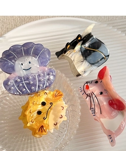 Close-up of animal-shaped acetate hair claws including cat and shell designs