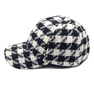 Detailed 45-degree angle of a classic black and white houndstooth wool baseball cap
