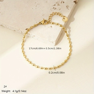 Close-up of golden beaded stainless steel bracelet with sizing details on stone slab