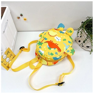 Macro view of adjustable yellow straps and dinosaur prints on kids backpack